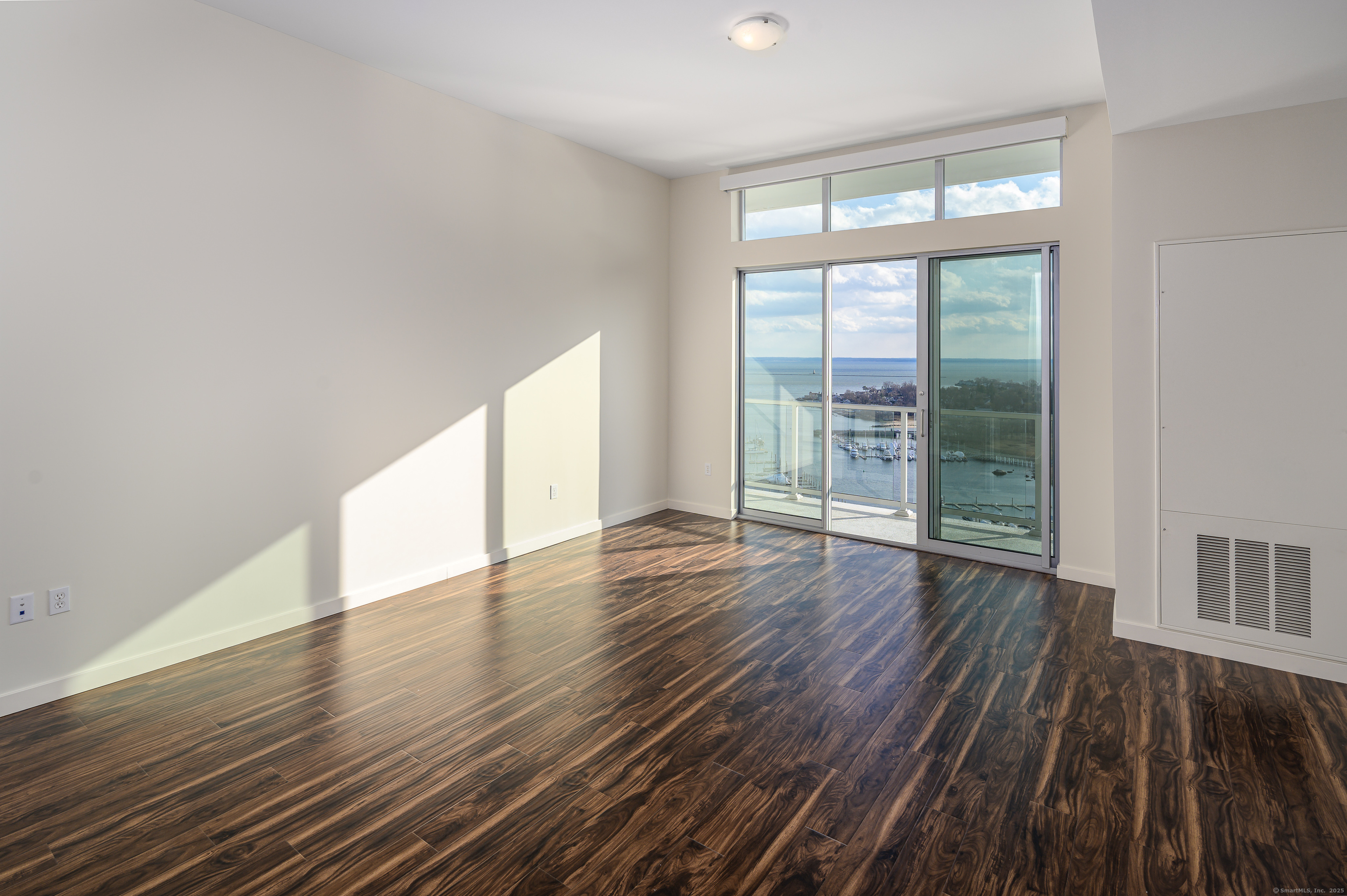1 Harbor Point Road, Unit 1 Stamford, CT 06902 - Photo 15 of 23 wooden floor in an empty room with a window