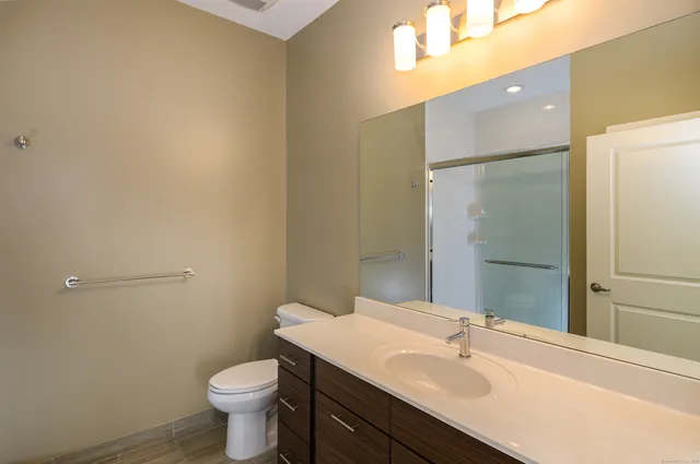 a bathroom with a sink toilet and shower