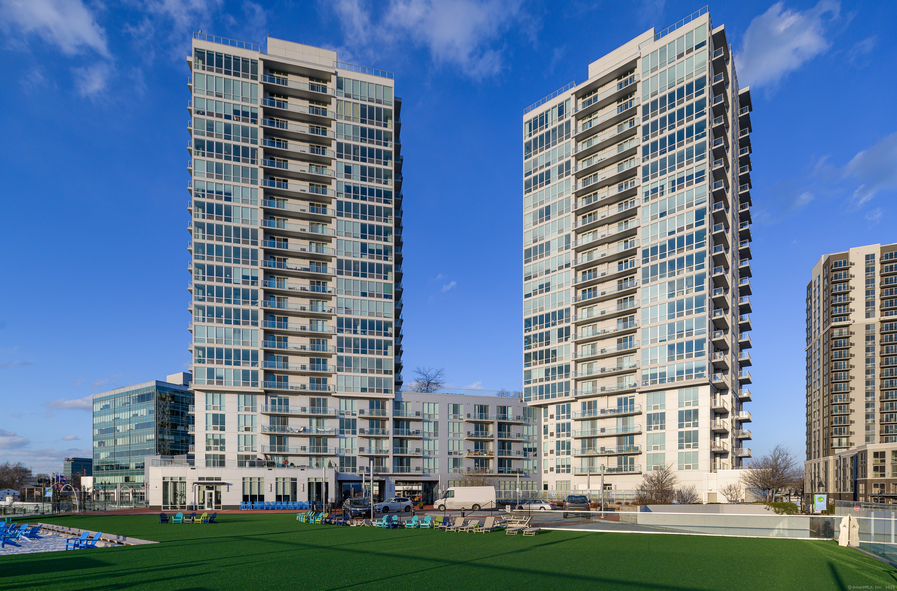 1 Harbor Point Road, Unit 1 Stamford, CT 06902 - Photo 21 of 23 front view of a building with a yard