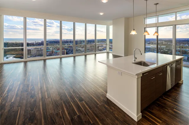 a kitchen with a sink and wooden floor