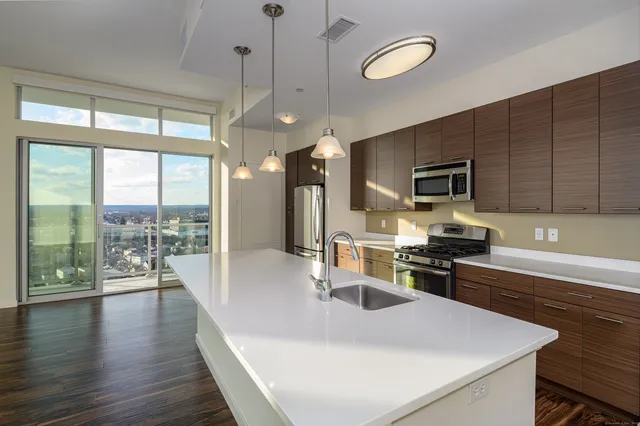 outdoor kitchen with stainless steel appliances granite countertop a sink a stove and a refrigerator