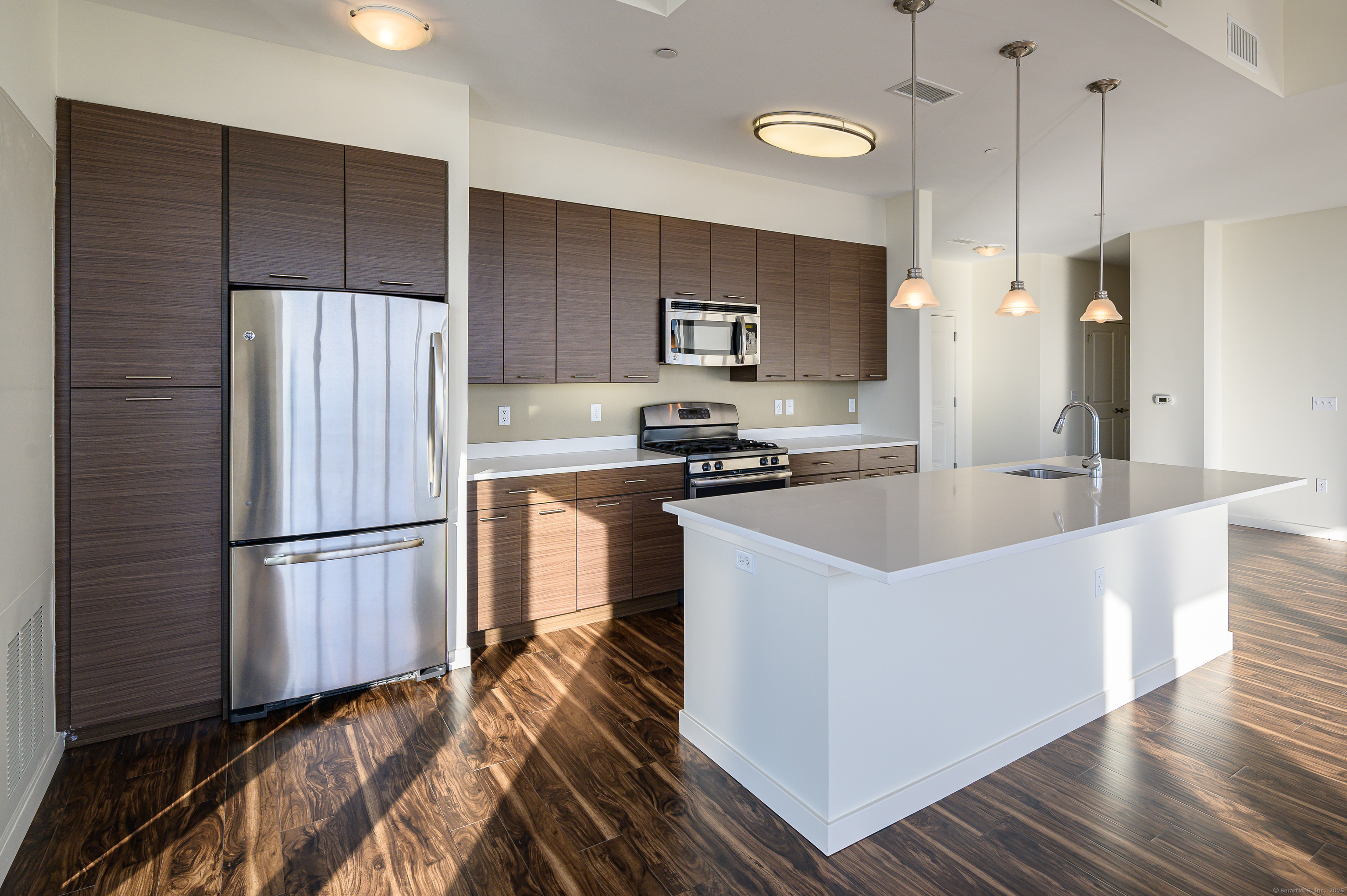 1 Harbor Point Road, Unit 1 Stamford, CT 06902 - Photo 6 of 23 a kitchen with a refrigerator a sink and wooden floor