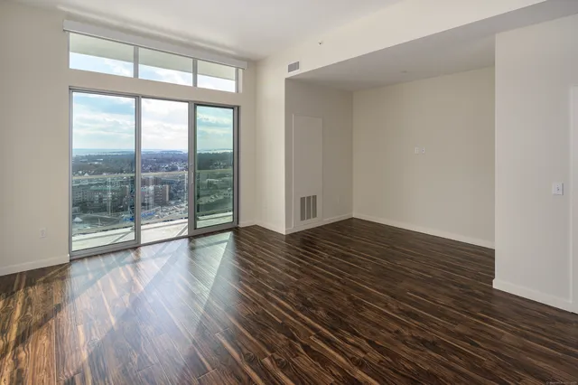 wooden floor in an empty room with a window