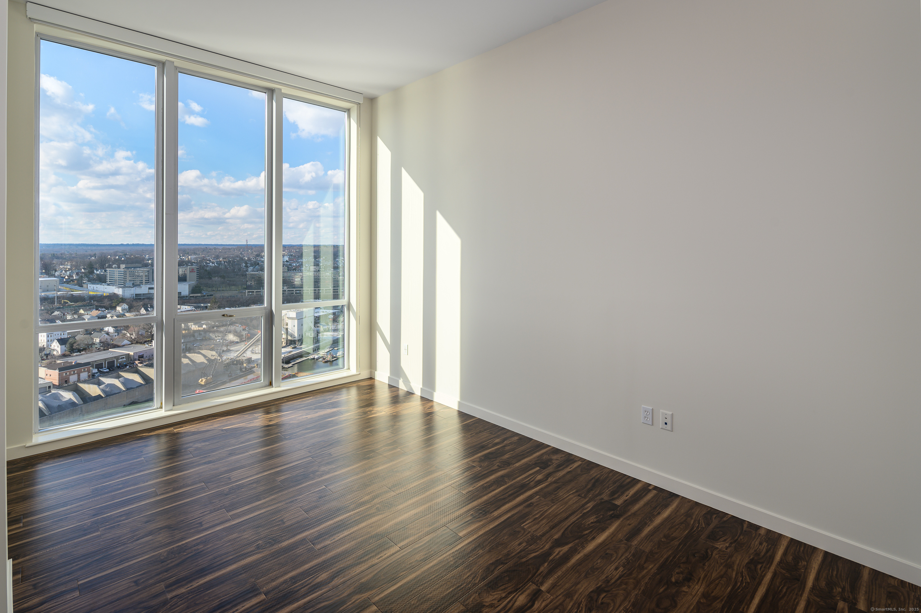 1 Harbor Point Road, Unit 1 Stamford, CT 06902 - Photo 10 of 23 a view of wooden floor and windows in a room