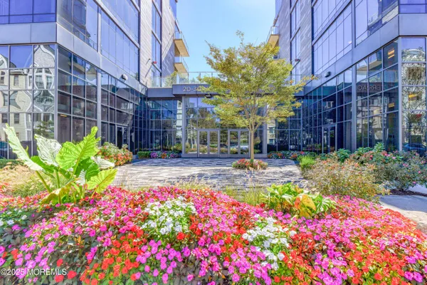 a front view of multi story residential apartment building with yard