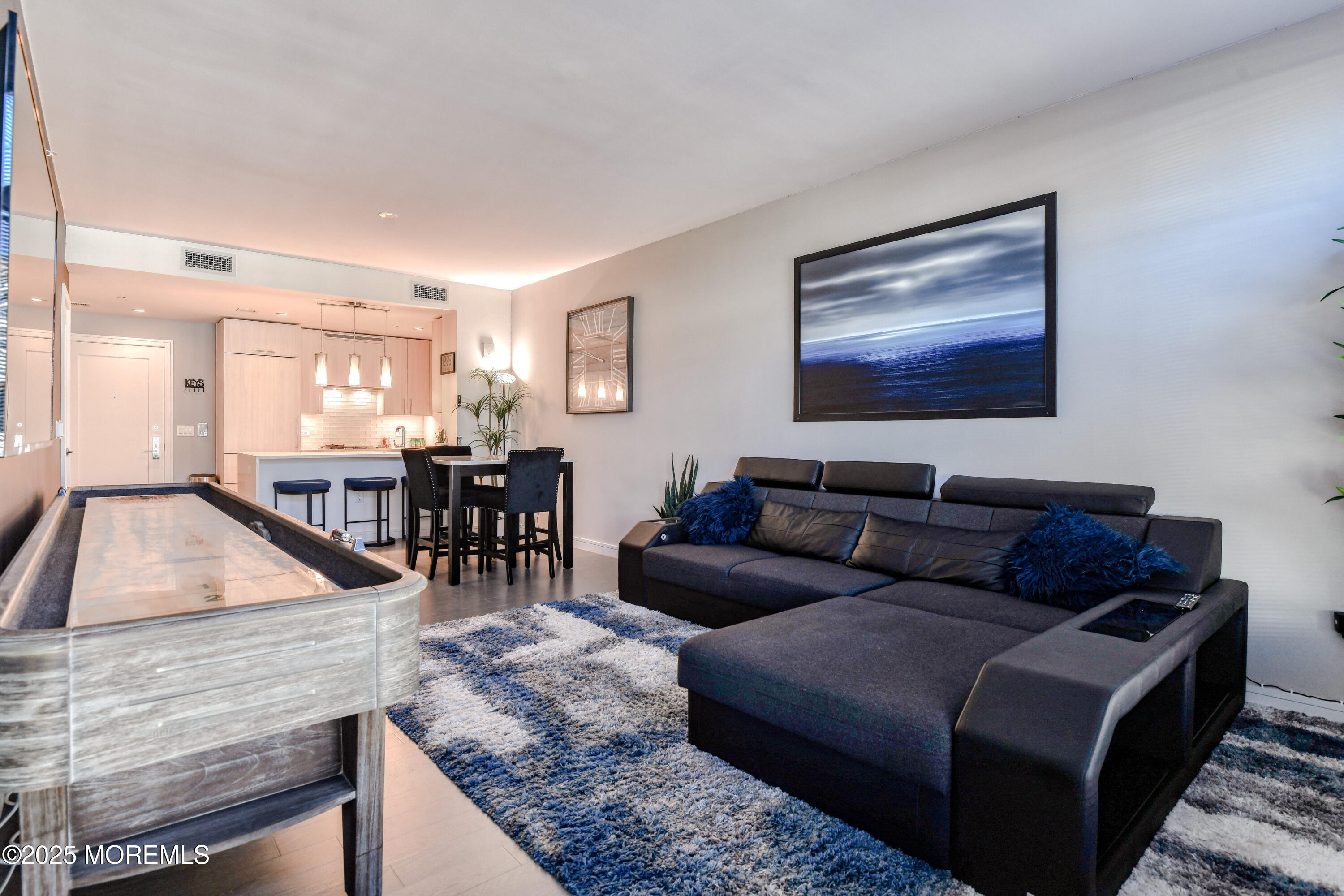 30 Melrose Terrace, Unit 303 Long Branch, NJ 07740 - Photo 16 of 54 a living room with furniture and a wooden floor