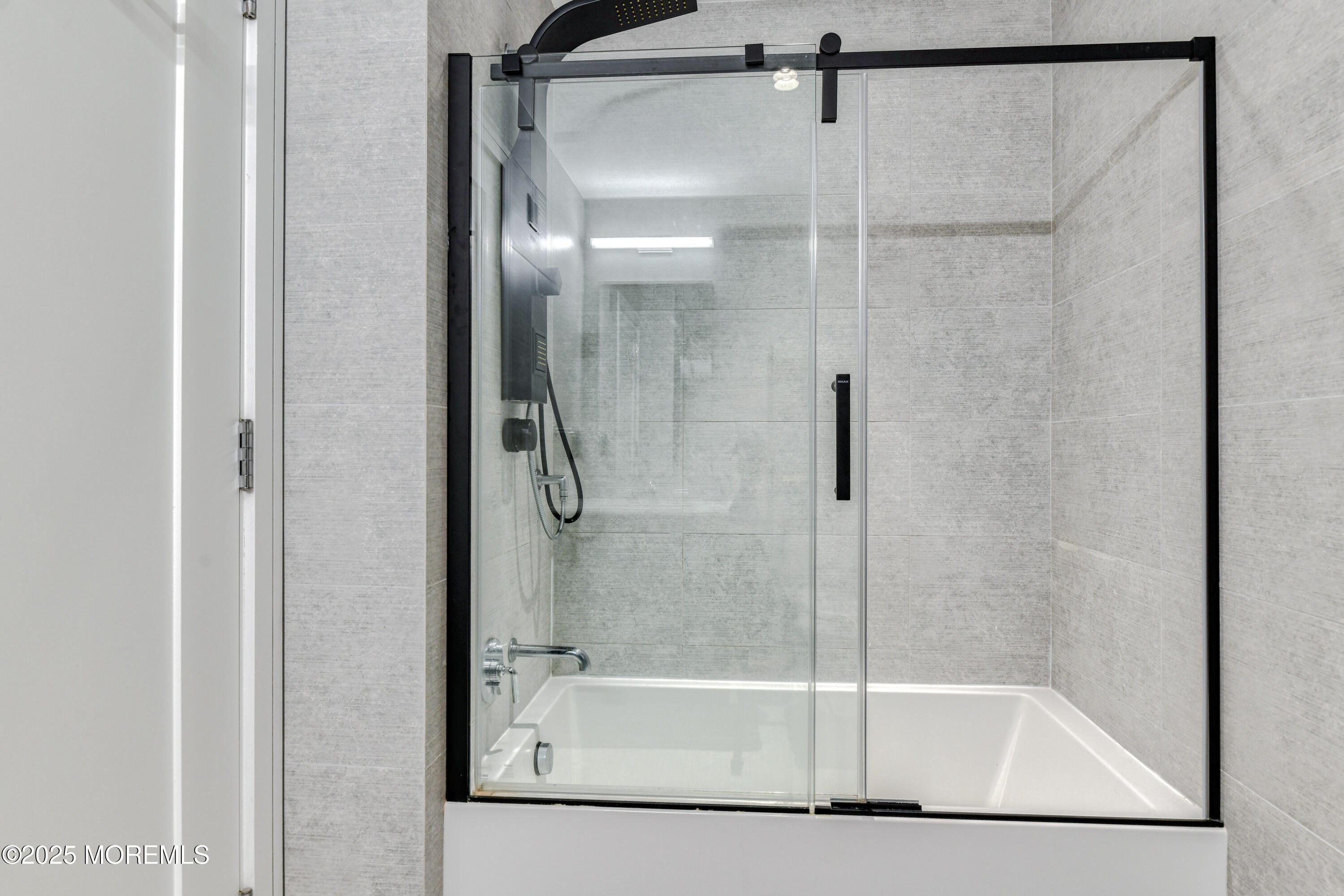 30 Melrose Terrace, Unit 303 Long Branch, NJ 07740 - Photo 23 of 54 a bathroom with a glass shower door