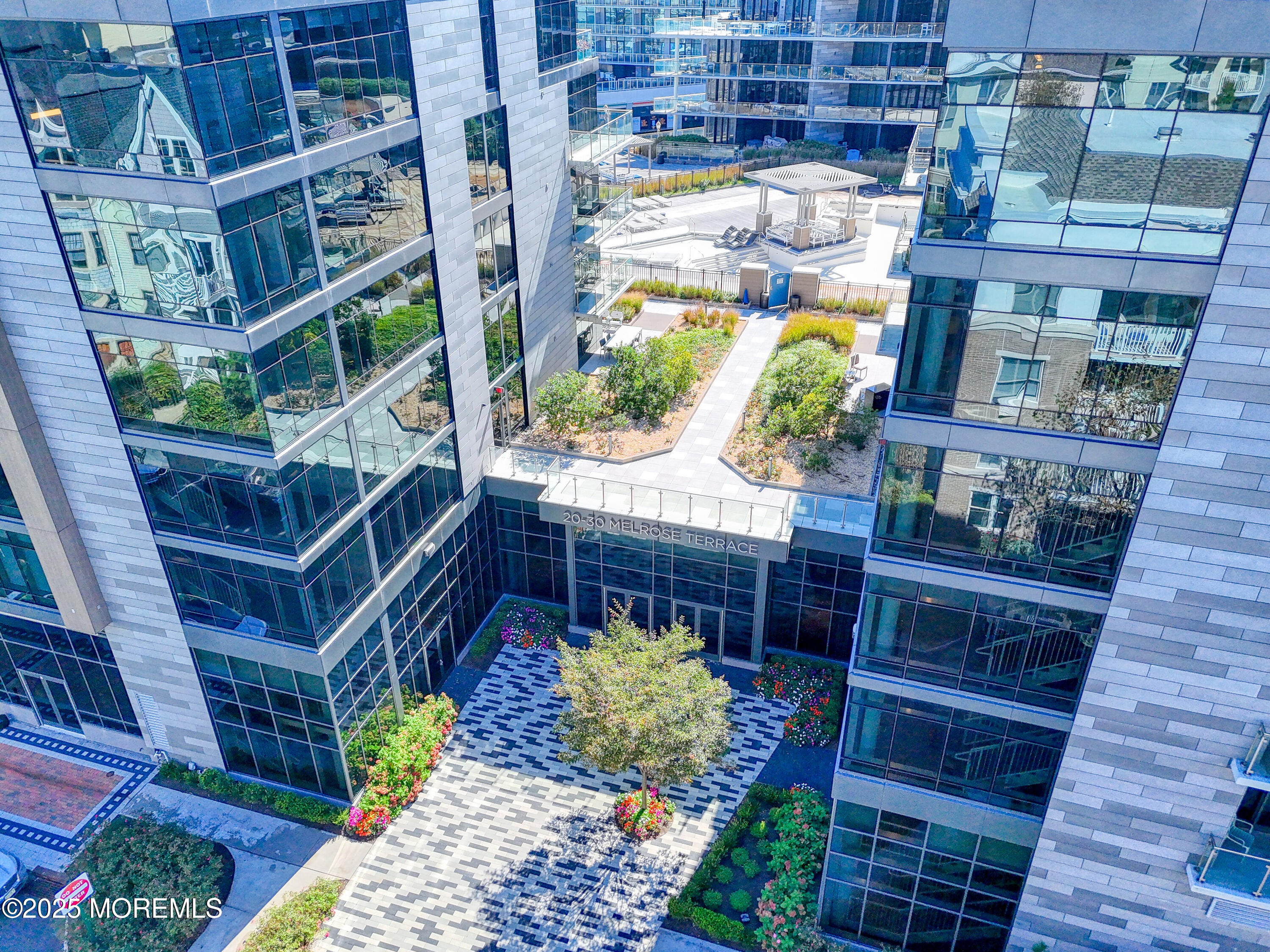 30 Melrose Terrace, Unit 303 Long Branch, NJ 07740 - Photo 3 of 54 a front view of a house with large windows