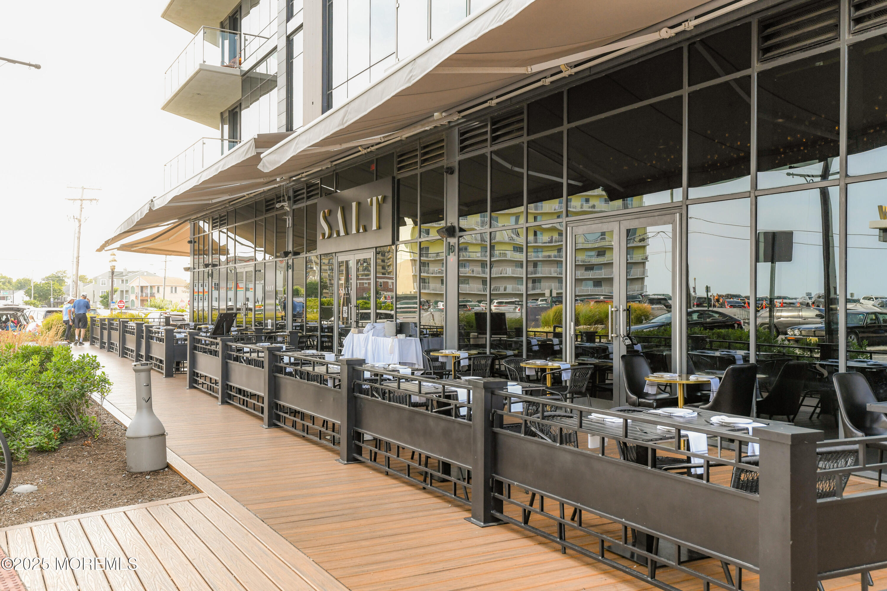 30 Melrose Terrace, Unit 303 Long Branch, NJ 07740 - Photo 49 of 54 a view of a patio with couches chairs dining table and chairs