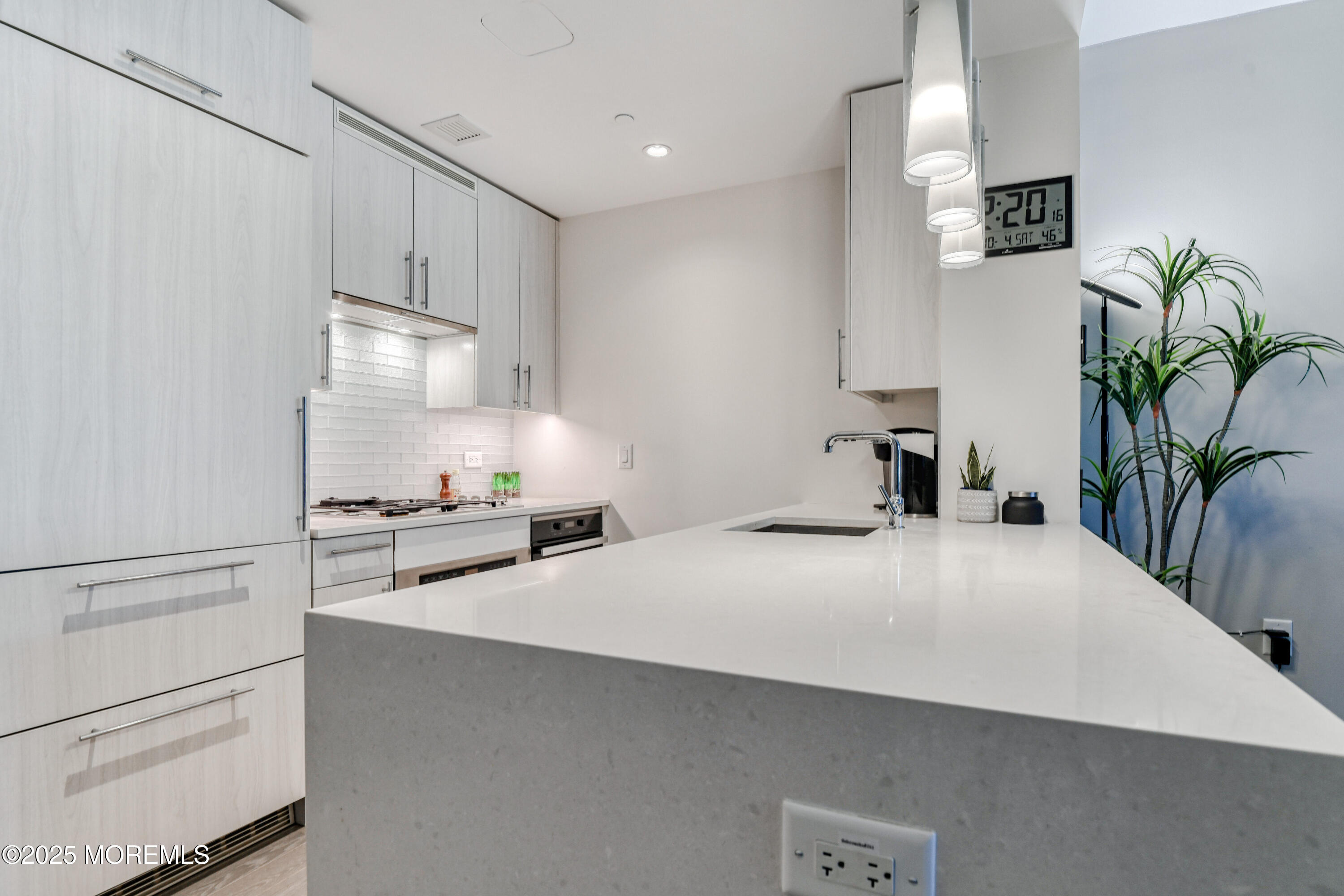 30 Melrose Terrace, Unit 303 Long Branch, NJ 07740 - Photo 9 of 54 a kitchen with stainless steel appliances a refrigerator sink and stove