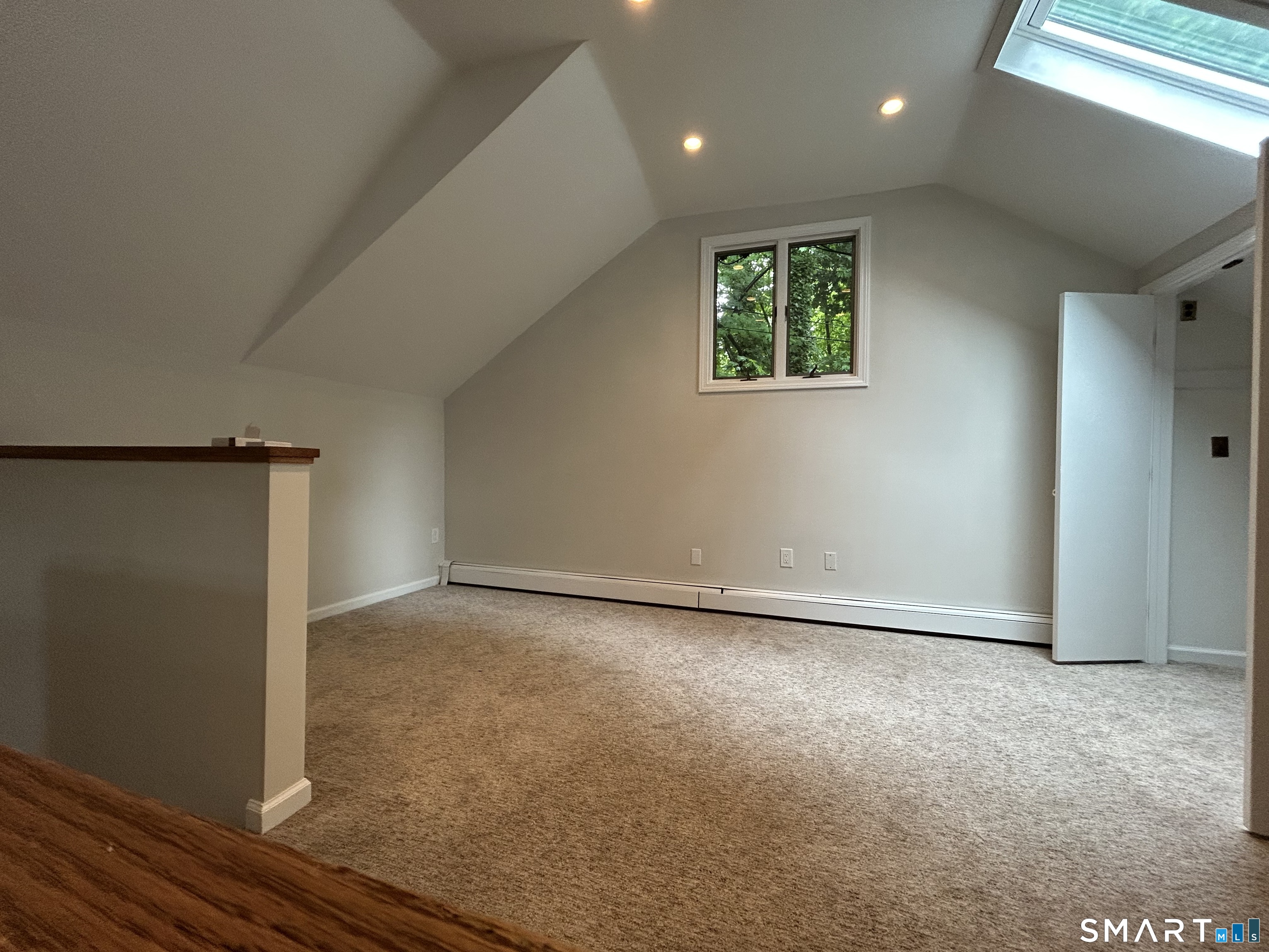 236 Wire Mill Road Stamford, CT 06903 - Photo 4 of 11 an empty room with wooden floor and windows