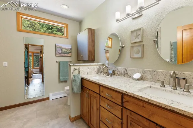 a bathroom with a granite countertop sink mirror and double