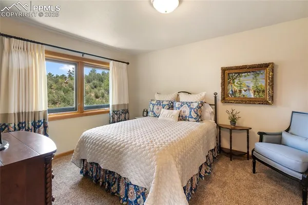 a bedroom with a bed and a table chair