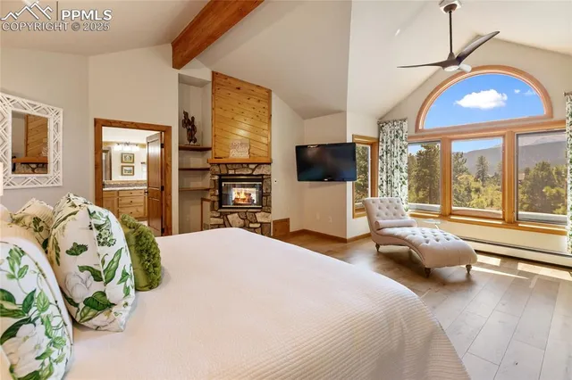 a bedroom with a bed and large windows