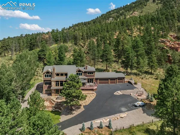 an aerial view of a house with a yard