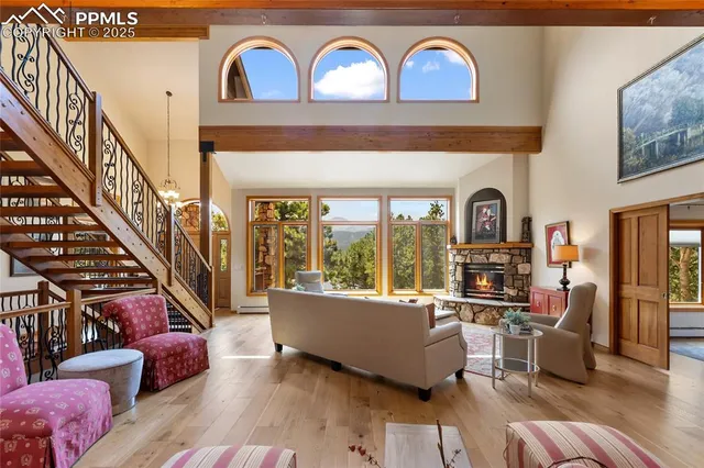 a living room with furniture and a floor to ceiling window
