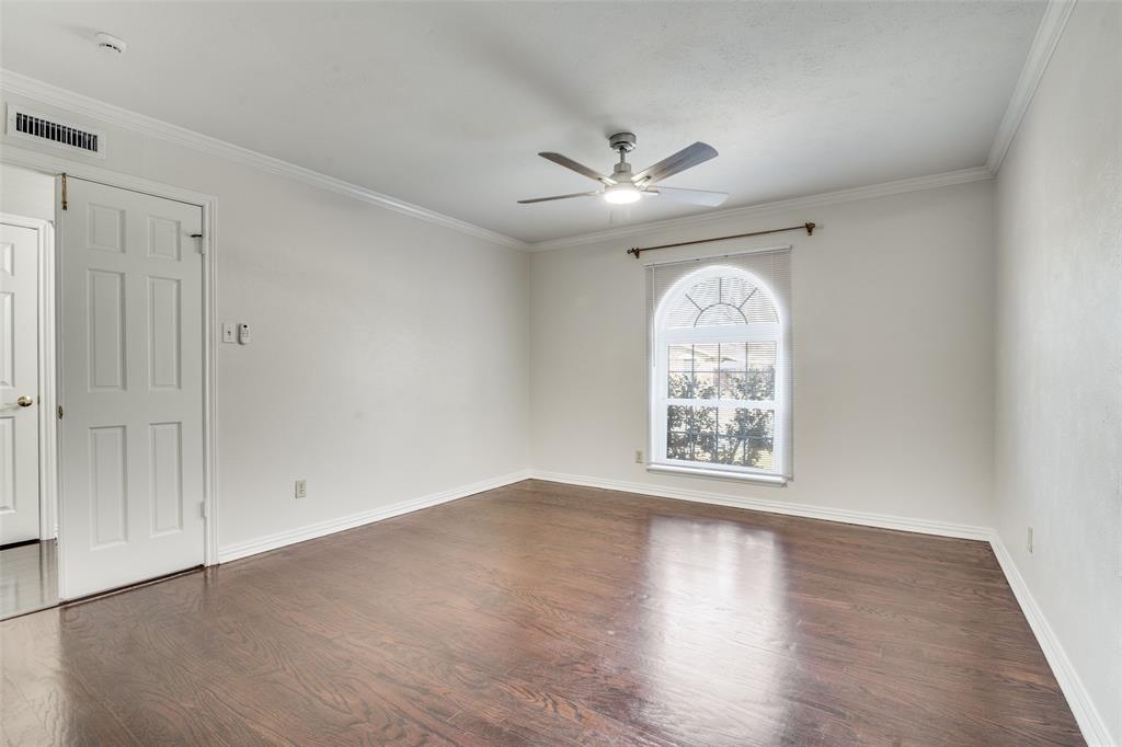 5602 Magnolia Lane Rowlett, TX 75089 - Photo 12 of 24 an empty room with wooden floor chandelier fan and windows
