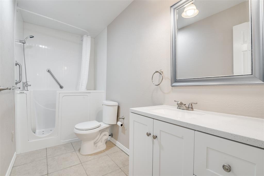 5602 Magnolia Lane Rowlett, TX 75089 - Photo 18 of 24 a bathroom with a sink toilet and vanity