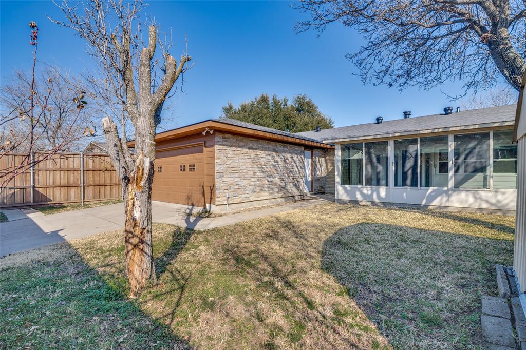 5602 Magnolia Lane Rowlett, TX 75089 - Photo 22 of 24 a view of a house with a yard
