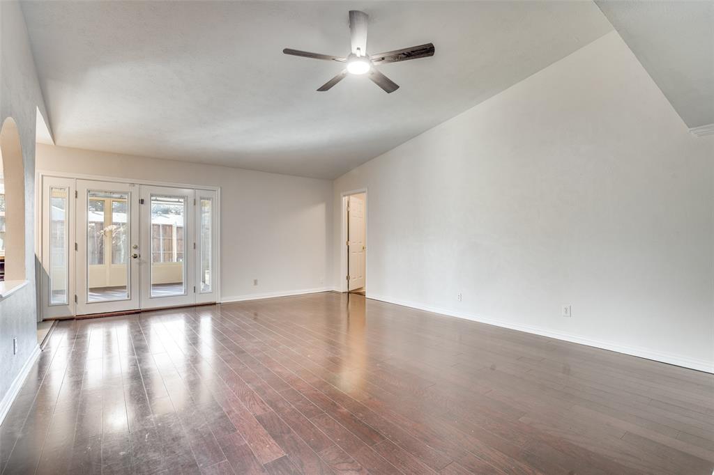 5602 Magnolia Lane Rowlett, TX 75089 - Photo 3 of 24 a view of an empty room with window and wooden floor