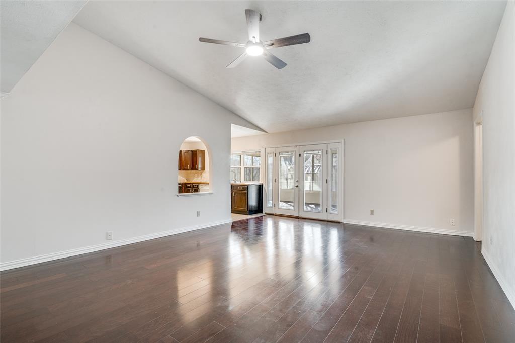 5602 Magnolia Lane Rowlett, TX 75089 - Photo 4 of 24 a view of an empty room with a window and wooden floor