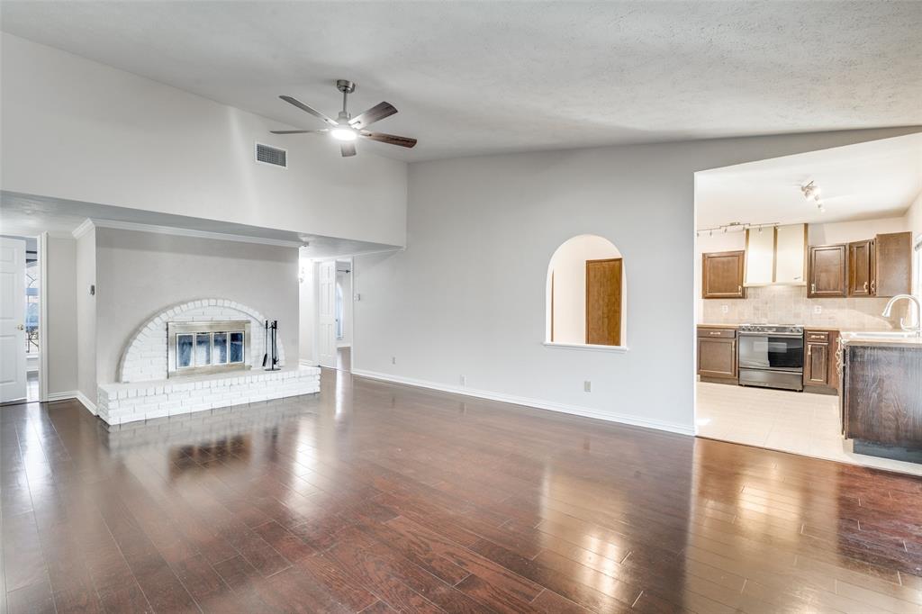 5602 Magnolia Lane Rowlett, TX 75089 - Photo 5 of 24 a view of an empty room with window and wooden floor
