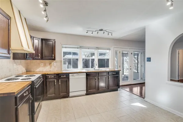 a kitchen with stainless steel appliances granite countertop a stove and a sink