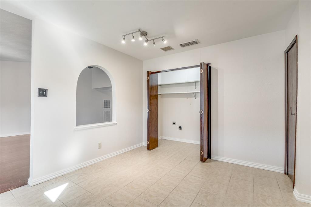 5602 Magnolia Lane Rowlett, TX 75089 - Photo 10 of 24 a view of an empty room with a chandelier fan