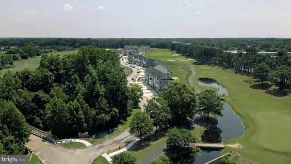 an aerial view of a houses with a yard