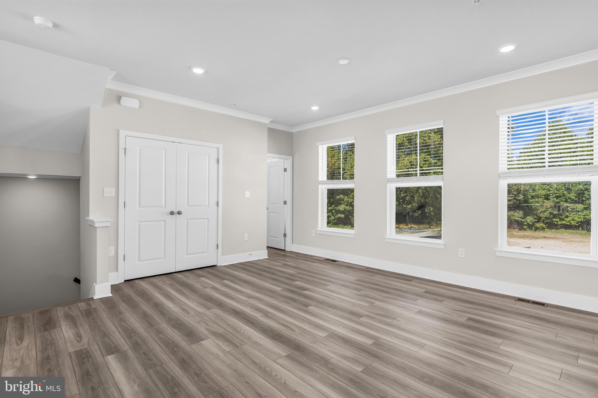2110 Winterberry Lane Cambridge, MD 21613 - Photo 11 of 46 a view of empty room with wooden floor and fan
