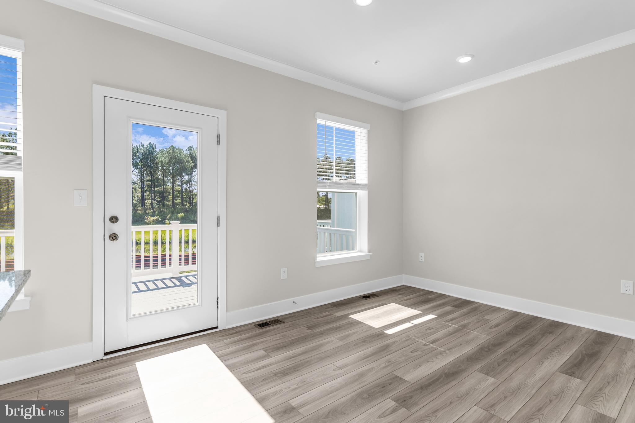 2110 Winterberry Lane Cambridge, MD 21613 - Photo 15 of 46 a view of empty room with wooden floor and fan