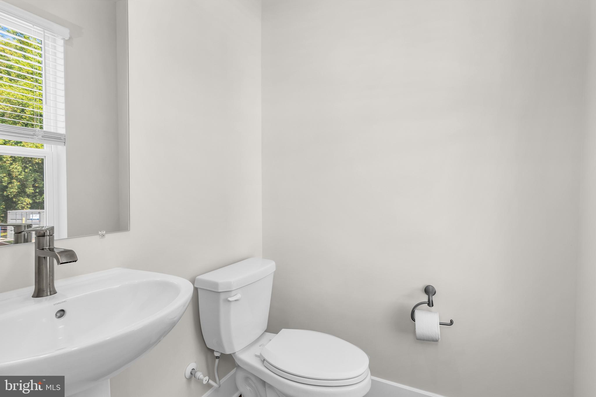 2110 Winterberry Lane Cambridge, MD 21613 - Photo 16 of 46 a white toilet sitting next to a white sink