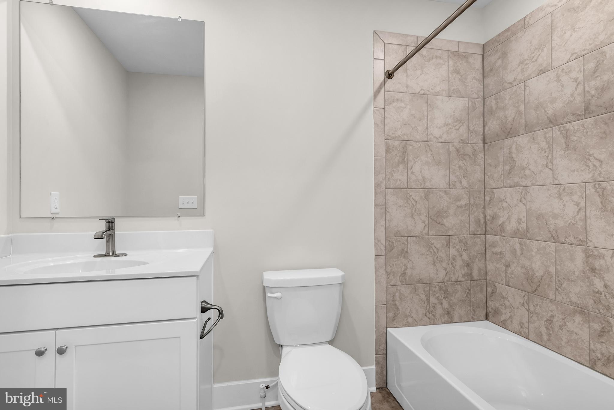 2110 Winterberry Lane Cambridge, MD 21613 - Photo 23 of 46 a bathroom with a toilet sink a mirror and bathtub