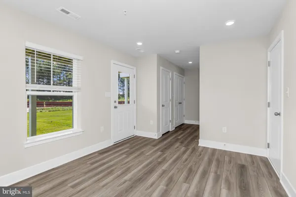 a view of a hallway with window and a bathroom