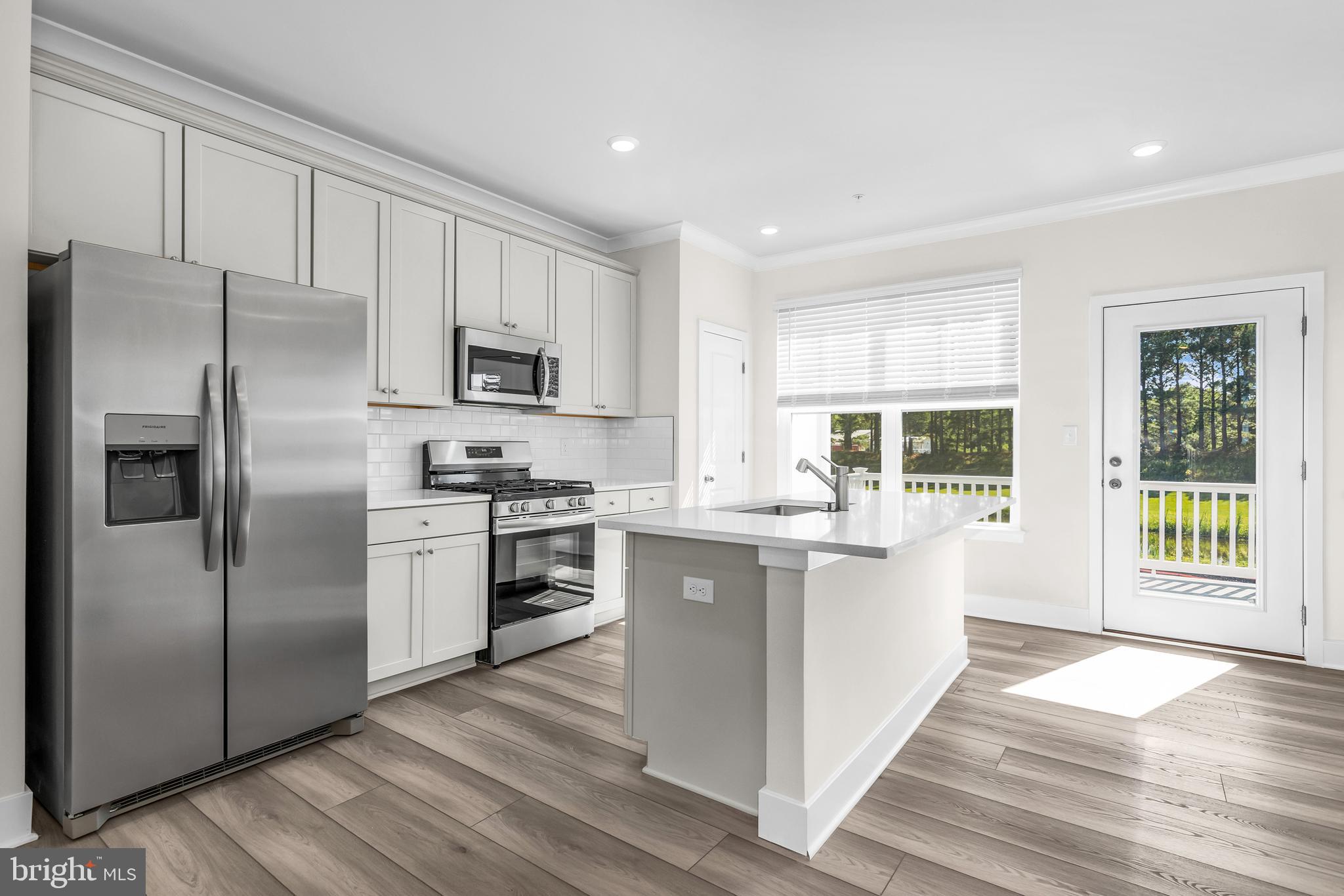 2110 Winterberry Lane Cambridge, MD 21613 - Photo 32 of 46 a kitchen with a refrigerator stove and microwave