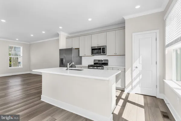 a kitchen with sink and windows