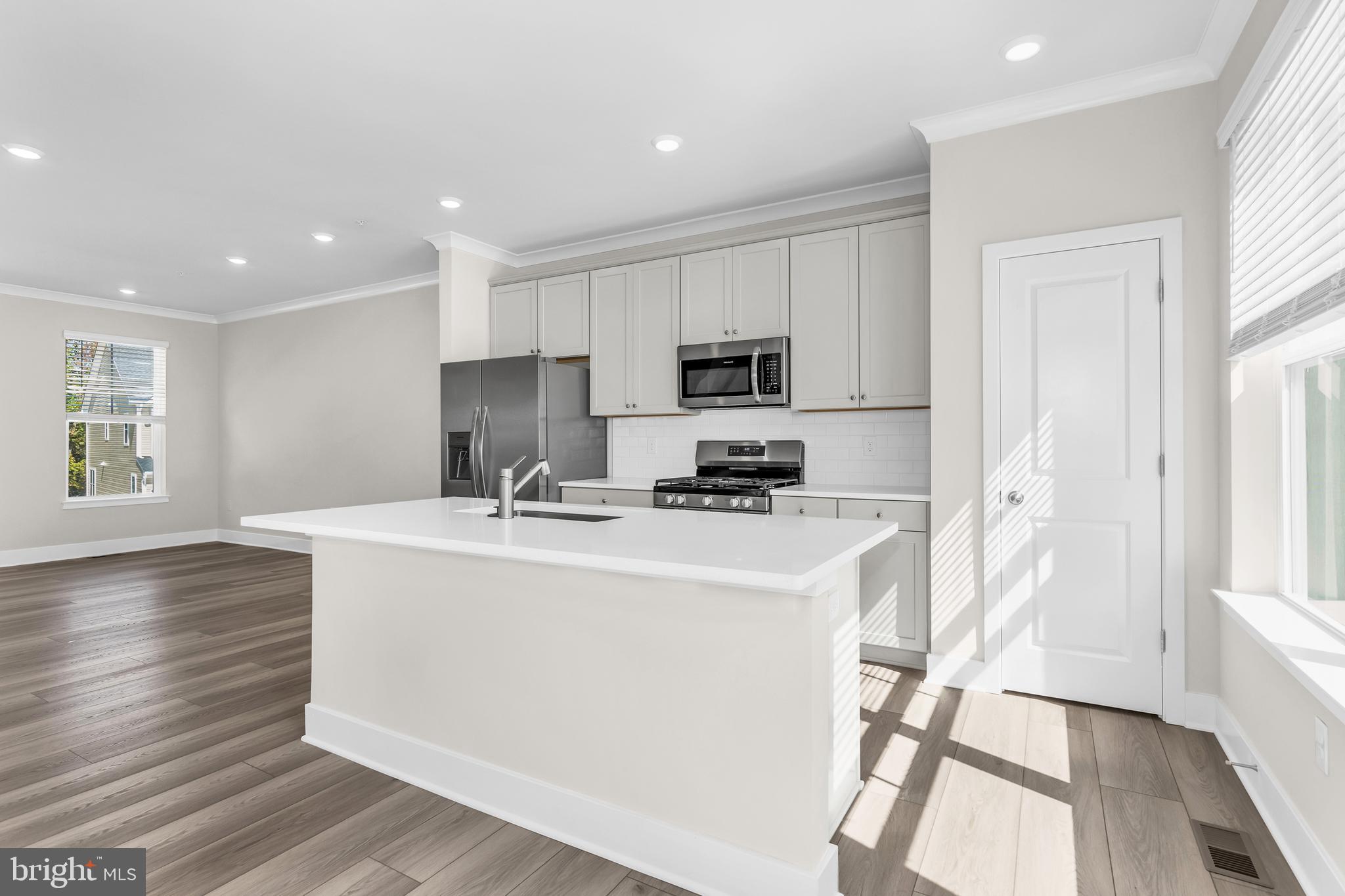 2110 Winterberry Lane Cambridge, MD 21613 - Photo 33 of 46 a kitchen with stainless steel appliances a microwave a sink a stove a refrigerator and cabinets