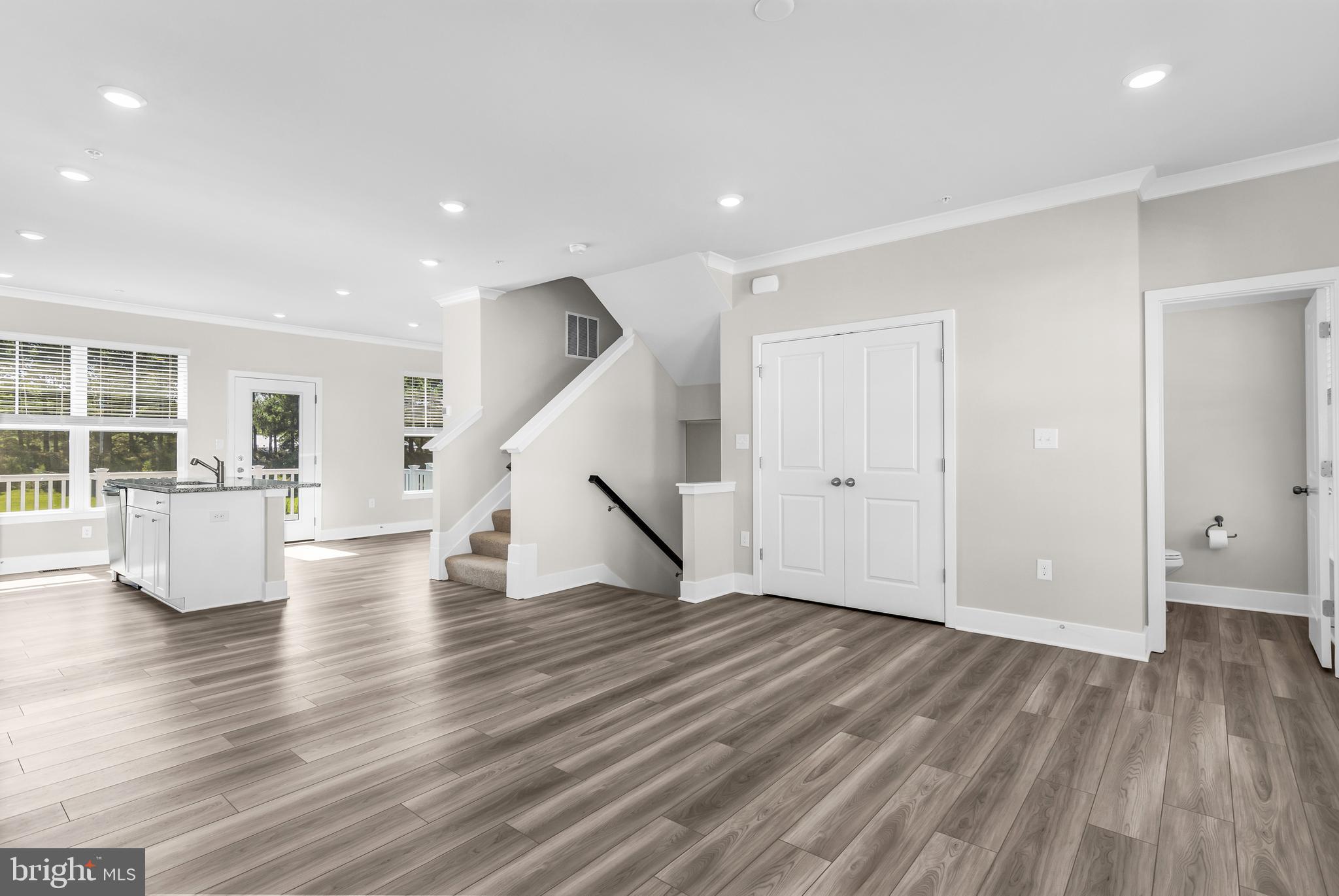 2110 Winterberry Lane Cambridge, MD 21613 - Photo 4 of 46 a view of an empty room with wooden floor and windows