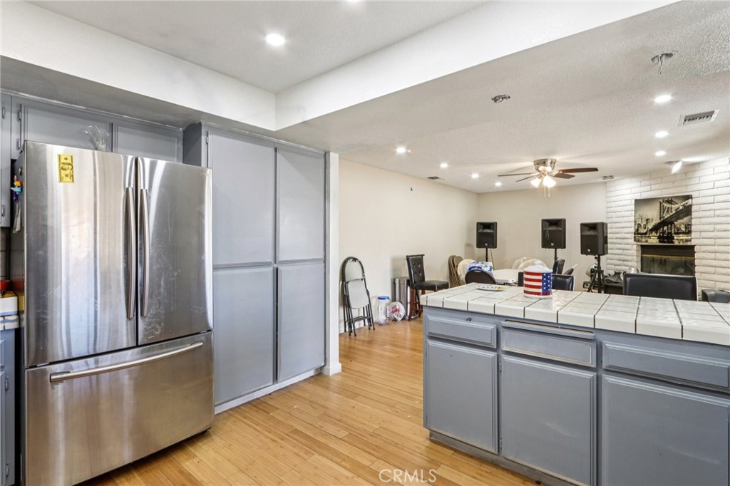 14057 Crow Road Apple Valley, CA 92307 - Photo 13 of 33 a room with stainless steel appliances kitchen island granite countertop a refrigerator and a sink