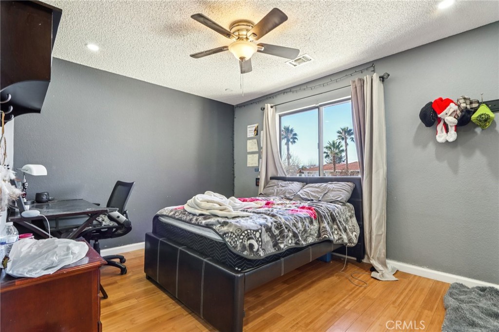 14057 Crow Road Apple Valley, CA 92307 - Photo 17 of 33 a bed room with a bed and a window