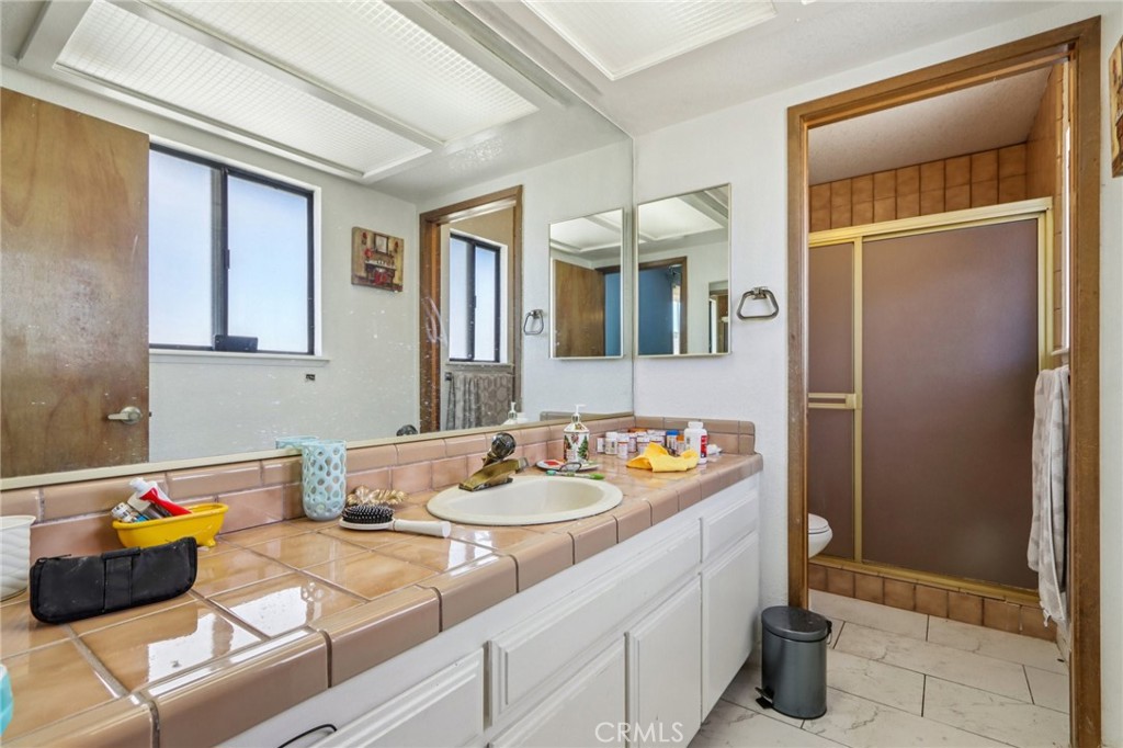 14057 Crow Road Apple Valley, CA 92307 - Photo 20 of 33 a bathroom with a sink a toilet and shower