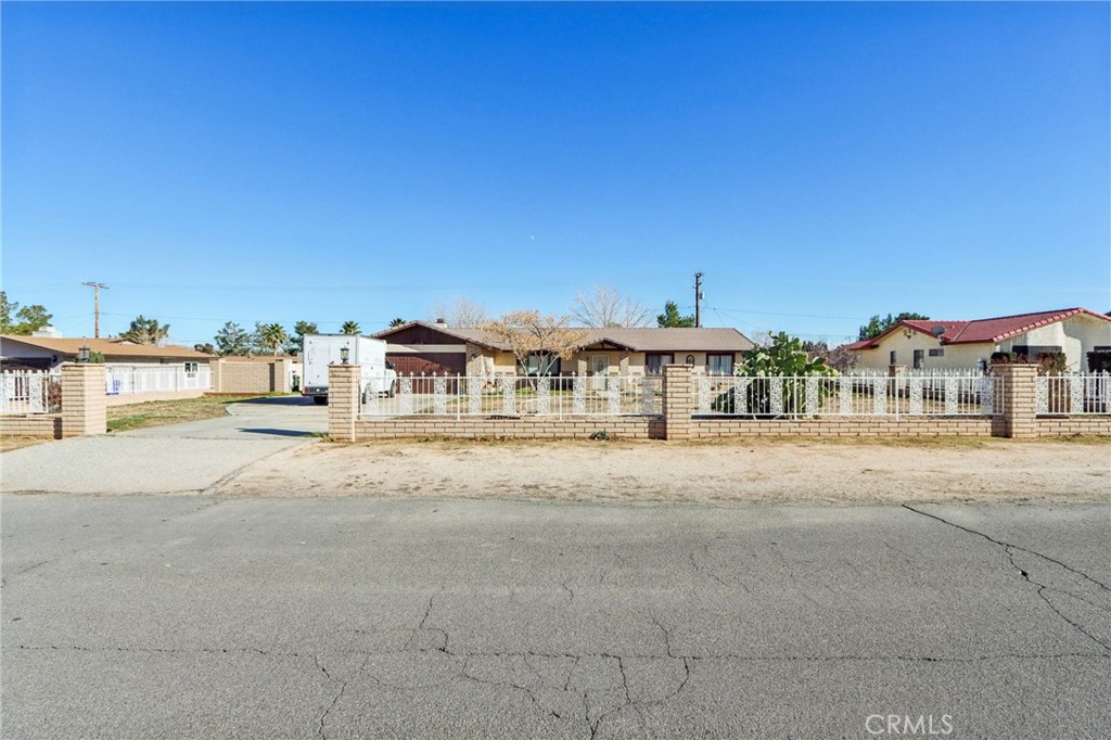 14057 Crow Road Apple Valley, CA 92307 - Photo 2 of 33 a front view of a building with a yard