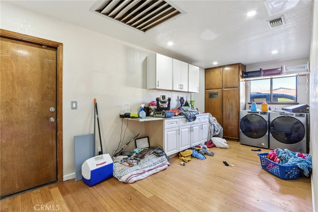 14057 Crow Road Apple Valley, CA 92307 - Photo 22 of 33 a room with furniture a flat screen tv and gym equipment