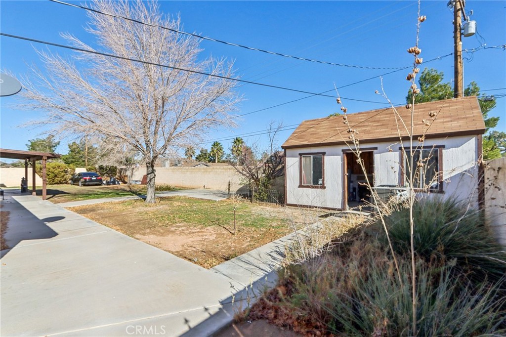 14057 Crow Road Apple Valley, CA 92307 - Photo 23 of 33 a front view of a house with a yard