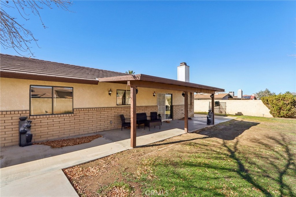 14057 Crow Road Apple Valley, CA 92307 - Photo 26 of 33 a front view of a house with a yard