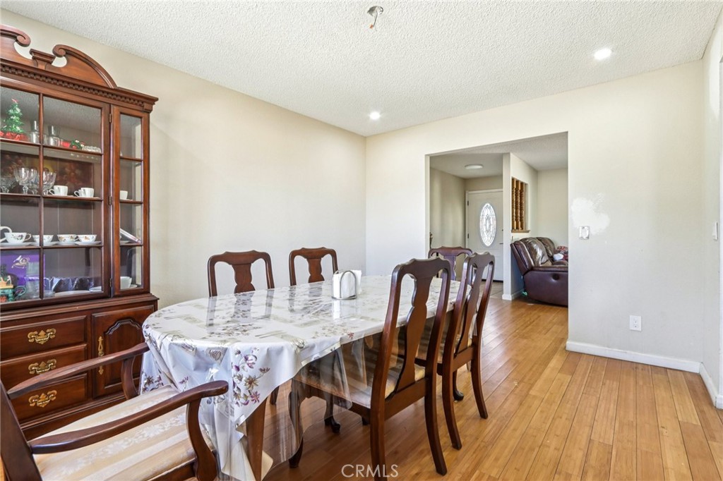 14057 Crow Road Apple Valley, CA 92307 - Photo 10 of 33 a view of a a dining room with furniture window and wooden floor