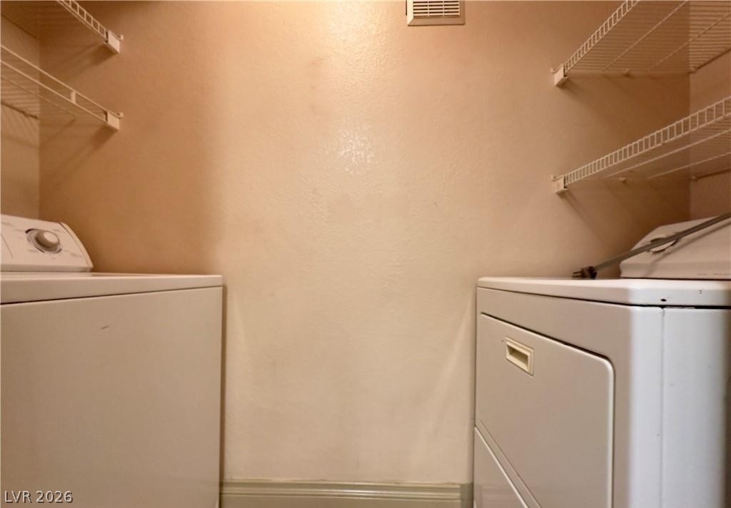 8101 West Flamingo Road, Unit 1082 Las Vegas, NV 89147 - Photo 12 of 23 A dedicated laundry space with convenient upper shelving.