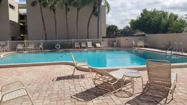 swimming pool with chairs in outdoor space