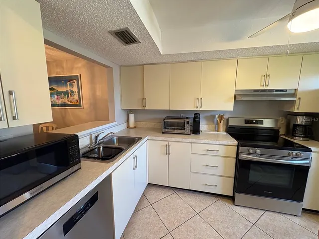 a kitchen with a stove and a sink