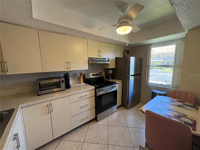 a kitchen with appliances cabinets and a counter top space